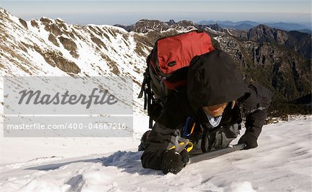 Mountaineer climb on snow slap on winter mountain.