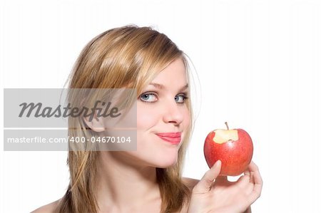 young blonde woman holding a red apple which has been bitten into