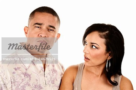 Pretty Hispanic wife looks suspiciously at her handsome husband