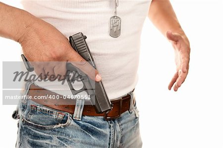 Closeup of man in t-shirt drawing gun from waist