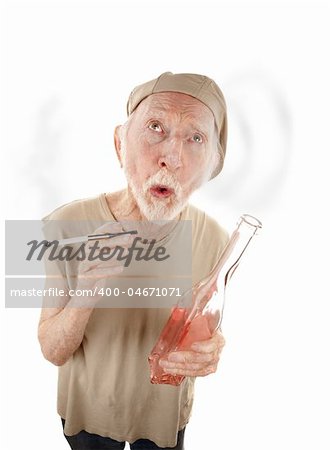 Senior man with liquor bottle blowing smoke rings