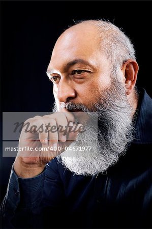 Stock image portrait of Man with long beard over dark background