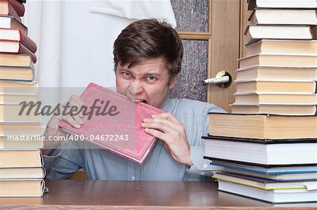 Crazy student gnaws red book between books