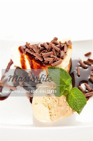 cheesecake  with ice cream, chocolate shavings and mint