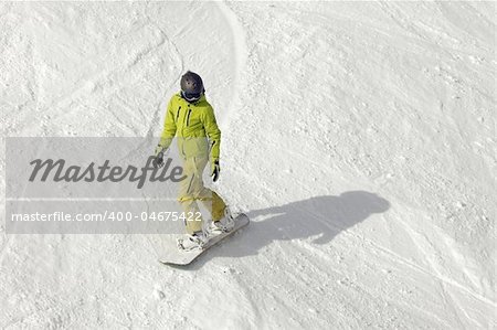 Snowboarder riding fresh powder snow