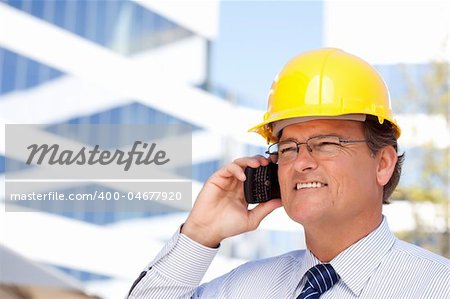 Handsome Contractor in Hardhat and Necktie Smiles as He Talks on His Cell Phone.