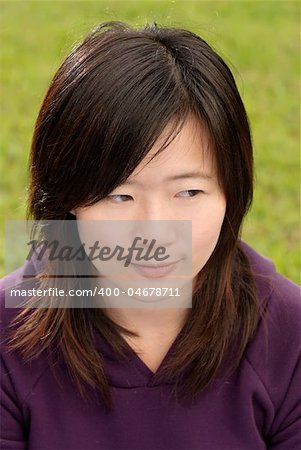 Asian beautiful woman portrait with thinking expression in outdoor of park.