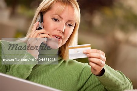 Cheerful Woman on Her Phone and Laptop with Credit Card.