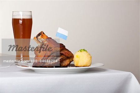 knuckle of pork with potato dumpling on a plate