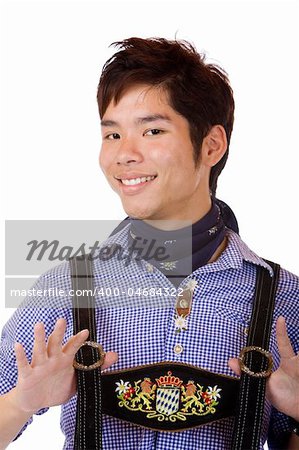 Closeup of Asian Boy dressed in Bavarian Oktoberfest Lederhose ands holding suspenders casual. Isolated on white.