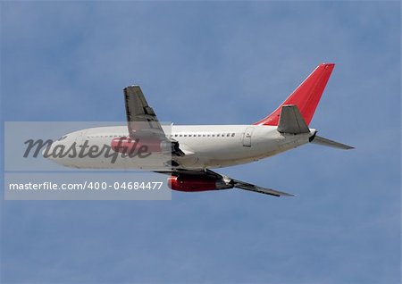 Passenger jet airplane taking off against blue sky