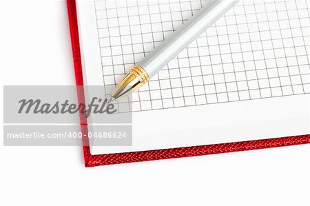red notebook with silver pen