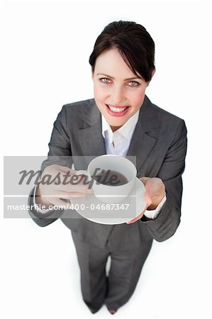 Confident businesswoman drinking a cup of coffee isolated on a white background