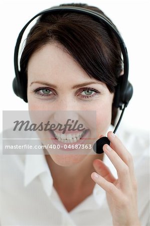 Businesswoman with headset on smiling at the camera isolated on a white background