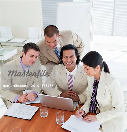 Positive business team working at a computer in a office