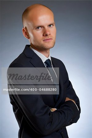 Portrait of happy stylish businessman smiling at camera isolated on dark background