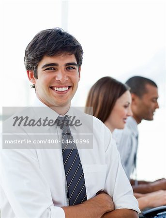 Portrait of elegant businessman in his office with his team