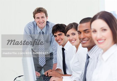 Charismatic manager and his team working at computers
