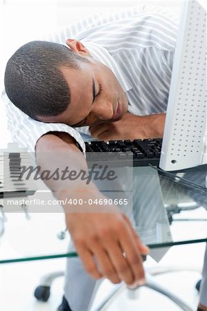 Close-ep of a tired businessman sleeping on his desk