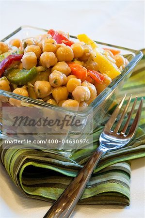 Vegan salad made from chick peas and mixed with spring onions, parsley, carrots, red and yellow pepper.  Topped with dressing made with olive oil, herbs and select spices.