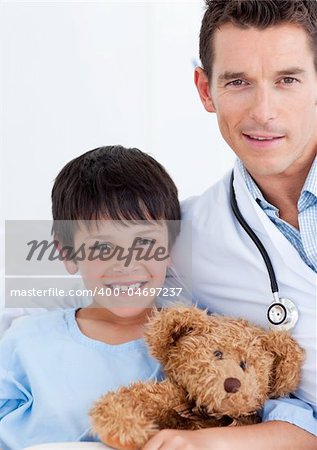 Portrait of a cute little boy and his doctor at hospital