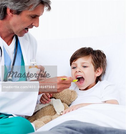 Child taking cough medicine in hospital