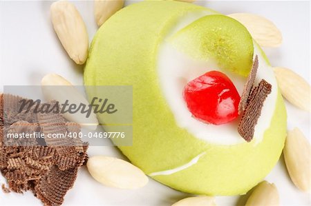 Close-up of a mini sicilian cassata with pieces of candied fruit, chocolate and almonds