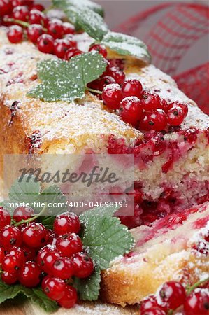 Homemade sponge cake with fresh organic red currants and sugar icing