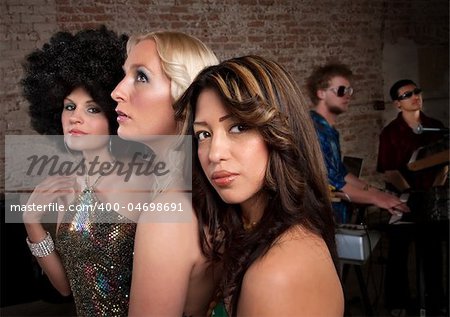 Cute girlfriends together at a 1970s Disco Music Party