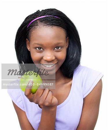 Smiling young woman eating an apple against a white background