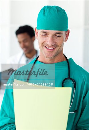 Attractive surgeon looking at a patient's folder in a hospital