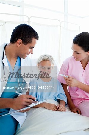 A nurse taking her patient's temperature in a hospital