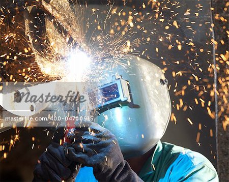 an arc welder working on a tub boat wheel