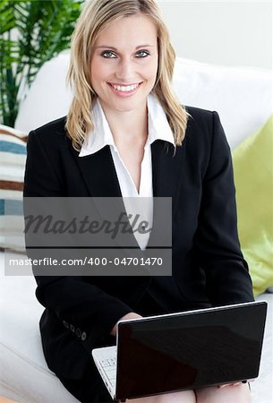 Confident businesswoman with  a laptop smiling at the camera