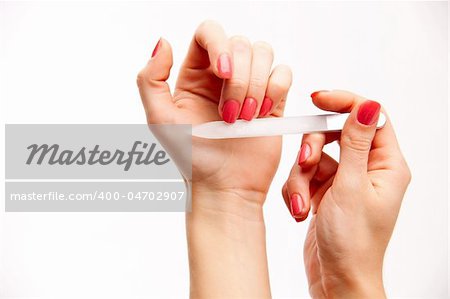 Female hands with the nails made up by a varnish straightening nails