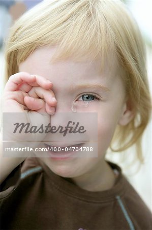 Adorable blond little girl crying closeup portrait