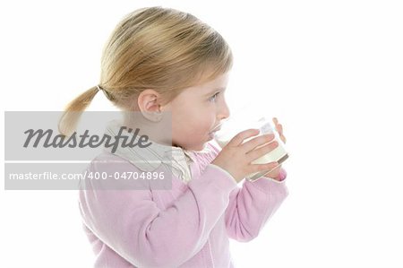 blond little girl drinking glass of milk isolated on white