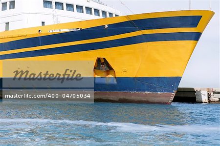 Boat bow in colorful yellow and blue colors turquoise sea