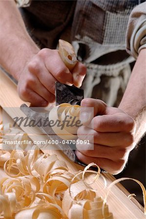 Man hands with carpenter's plane on wooden background