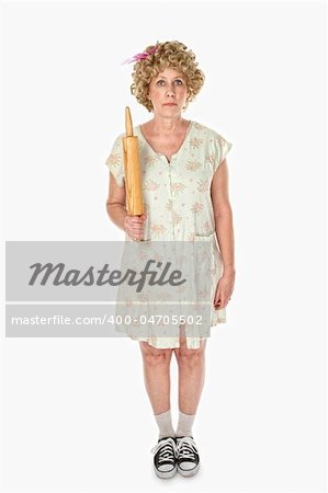 Unmoving housewife with rolling pin on white background