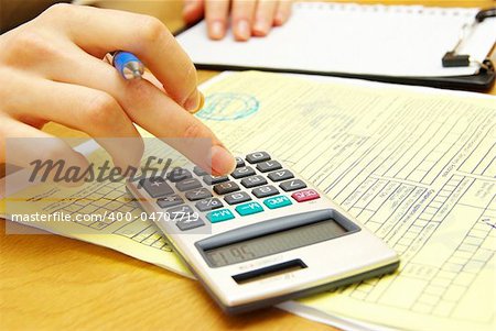 Closeup of a young women calculating bills