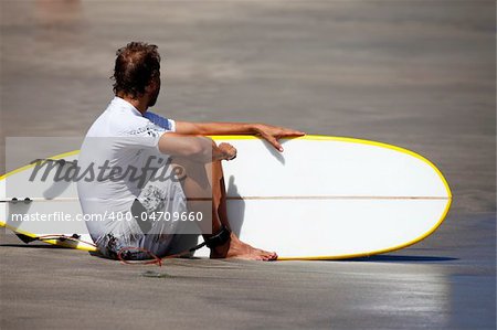 Surfer on a coastline expecting the big wave. Bali