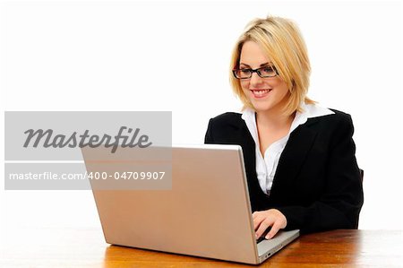 Happy young successful woman sitting at desk with laptop isolated on white