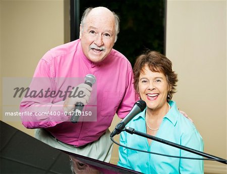 Talented senior couple sings and plays piano.