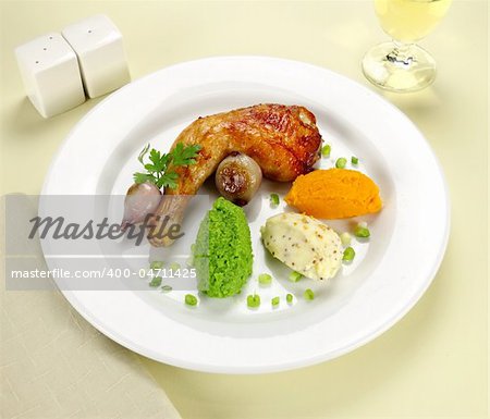 Baked chicken quarter with mashed peas, pumpkin and potato with onions.