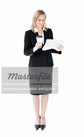 Attractive businesswoman reading a newspaper holding a coffee against white background
