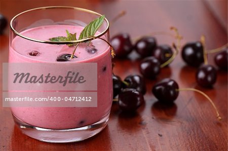 Fresh cherry milk shake in a glass. Shallow DOF