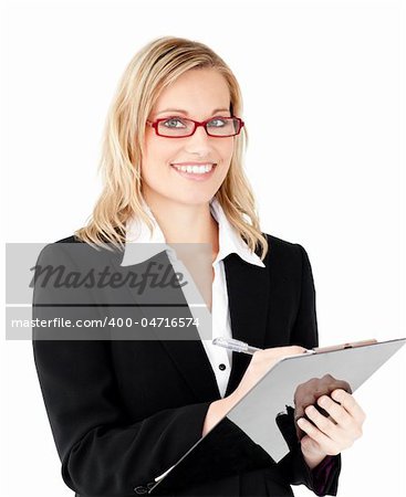 Charming businesswoman writing on a clipboard against white background