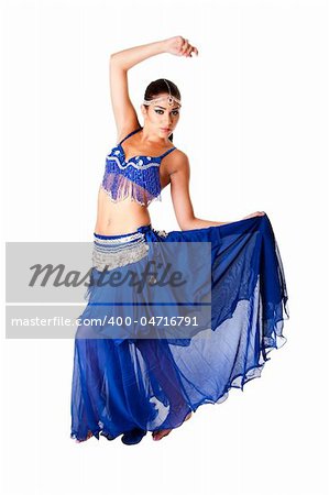 Beautiful Arabic belly dancer harem woman in blue with silver dress and head jewelry with gem dancing holding skirt, isolated.