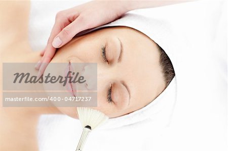 Young caucasian woman enjoying a beauty treatment in a spa center